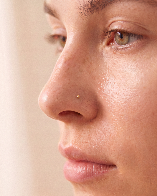 14k solid gold ball nose ring worn on model