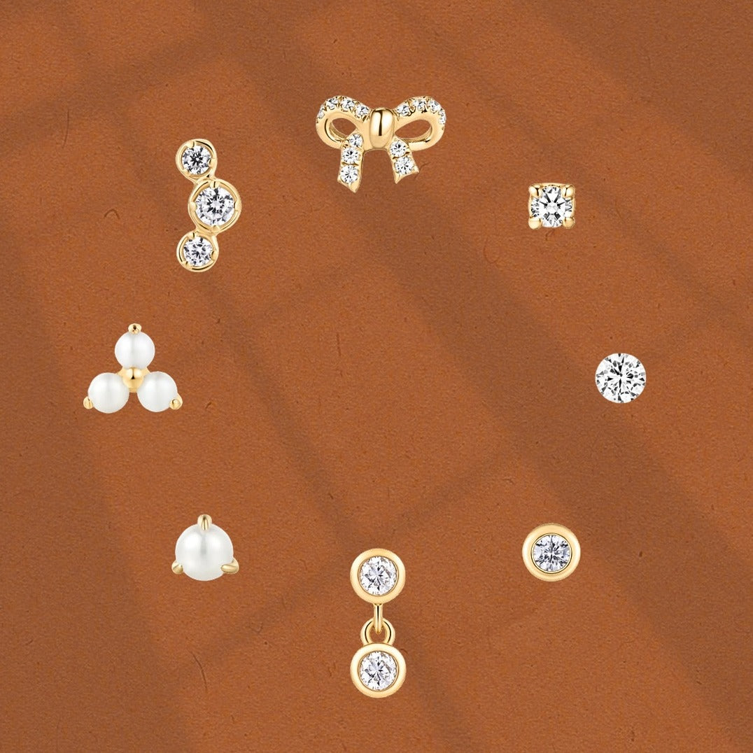 Eight 14k solid gold flatback piercings in a circle
