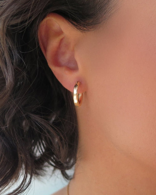 Small Thick Hoop Earrings in 14k yellow gold fill, side profile on the ear | The Littl