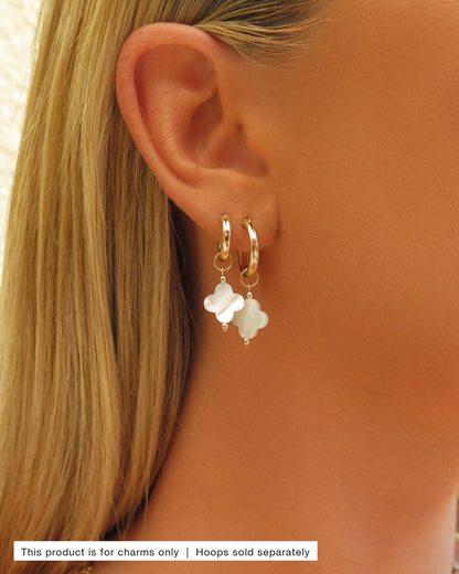 Mother of Pearl Clover Hoop Earring Charms worn on gold Thick Hoop Earrings in an ear stack | The Littl