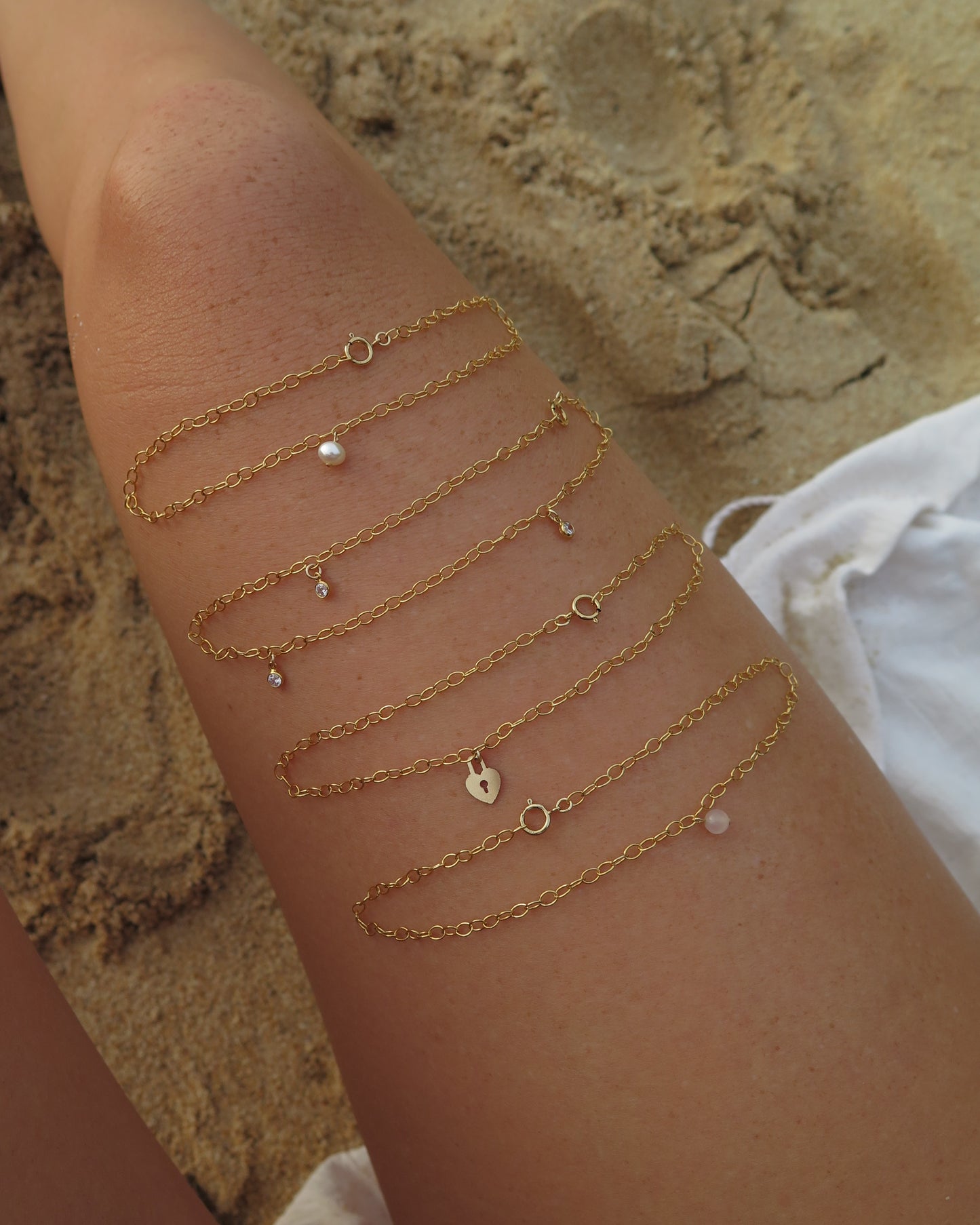 Gold-filled chain anklets by The Littl flat lay