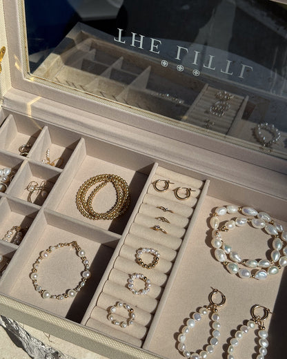 Deluxe Jewellery Box open with its logo lid up, holding pearl and gold pieces | The Littl