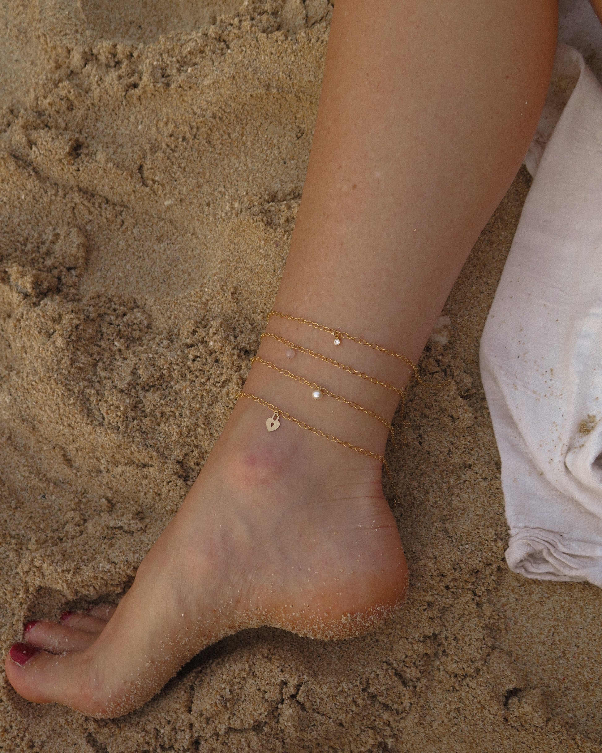 The Littl 14k gold-filled anklet collection styled together