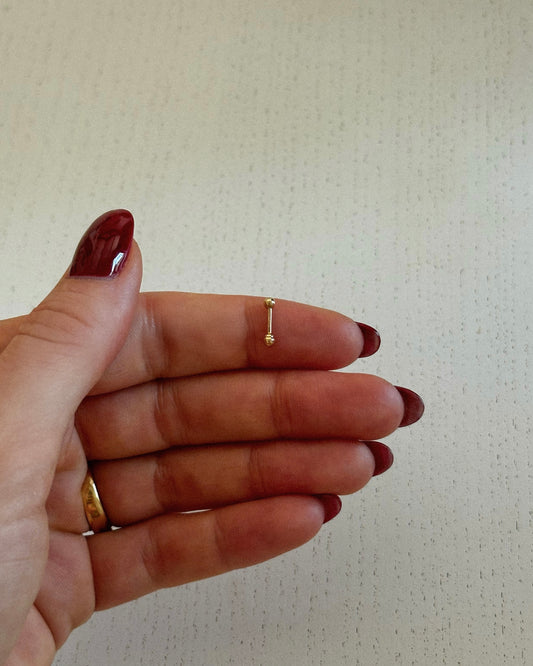 Straight Barbell in 14k solid gold, held