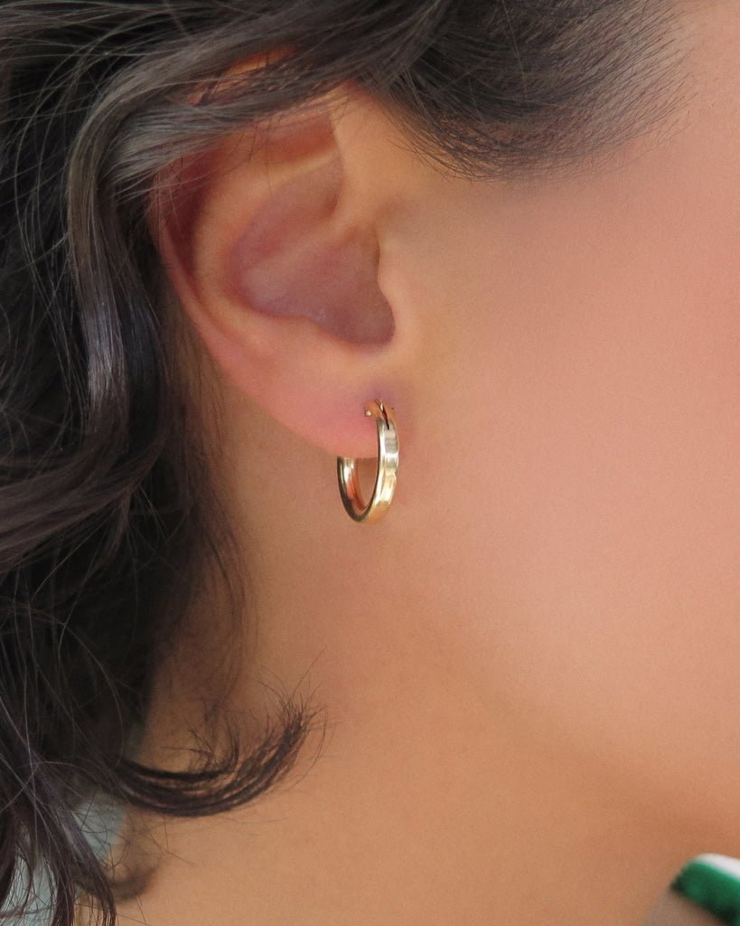 Small Thick Hoop Earrings in 14k yellow gold fill, 3mm band shown on the ear | The Littl